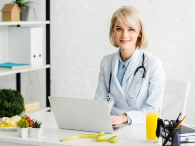 cheerful-blonde-nutritionist-sitting-near-laptop-and-glass-of-fresh-orange-juice.jpg cheerful-blonde-nutritionist-sitting-near-laptop-and-glass-of-fresh-orange-juice.jpg